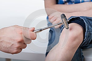 Orthopedist during examining a boy photo