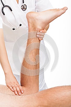 Orthopedist examining man's legs photo