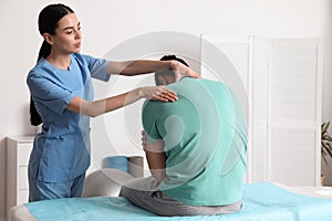 Orthopedist examining man`s neck. Scoliosis treatment