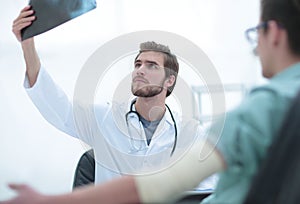 Orthopedist examining a radiograph of a patient