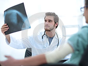 Orthopedist examining a radiograph of a patient