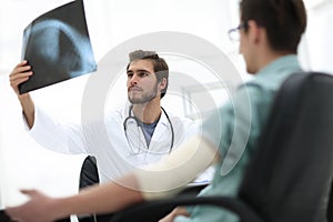 Orthopedist examining a radiograph of a patient