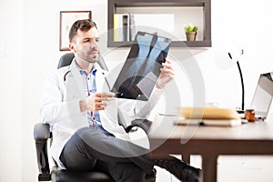 Orthopedist looking at x-rays from a patient