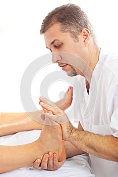 Orthopedist man massaging foot photo
