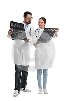 Orthopedists holding X-ray pictures on background