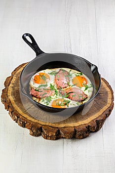 ortioned baked eggs in ceramic cocotte with Different delicious egg recipes