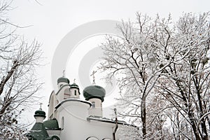 Ortodox slavic church in a winter time over grey sky background.