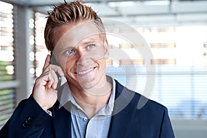 Ortrait of handsome business man using cell phone