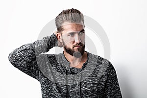 Ortrait of a man, thinking about something, scratching a his head