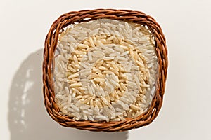 Whole Chinese Rice seed. Top view of grains in a basket. Close photo