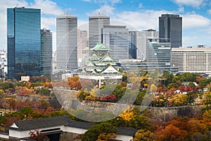 Osaka Castle with Japanese garden and city office building skyscraper at autumn season in Osaka, Japan. Japan tourism, history