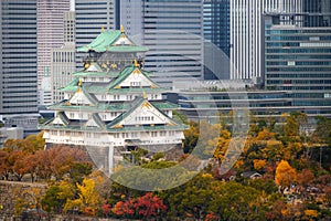 Osaka Castle with Japanese garden and city office building skyscraper at autumn season in Osaka, Japan. Japan tourism, history