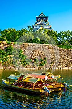 Osaka castle and traditional tour boat, a famous landmark in Osaka, Japan
