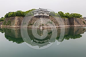 Osaka castle walls reflecting in water