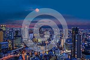 Osaka city skyline under moonlight at night