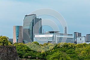 Osaka, Japan city skyline at the castle and business park in the photo
