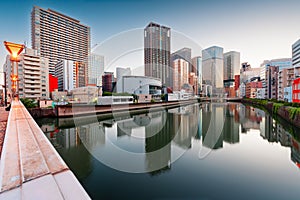 Osaka, Japan cityscape on the river at dusk photo