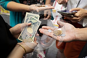 Osaka japan - november8,2018 : unidentified people counting japanese yen coint and banknote in osaka city market