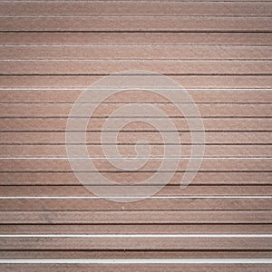 OSB sheets are stacked in a hardware store. The building material is wood