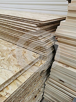 OSB sheets are stacked in a hardware store. The building material, wooden paneles photo
