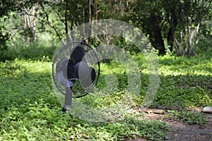 Oscillating black fan in the grass