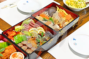 Osechi, traditional Japanese New Year food, in black lacqueware boxes