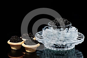 Osetra caviar in ice and tartlets photo