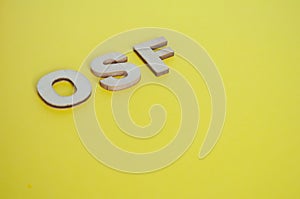 OSF wooden letters representing Open Science Framework on yellow background