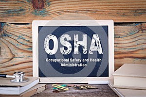 Osha, Occupational Safety and Health Administration. Chalkboard on a wooden background