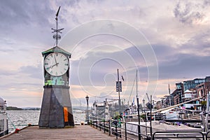 Oslo, Norway - Modernistic Aker Brygge district of Oslo with historic Clock Tower at the pier of Oslofjorden shore