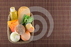 Ð¡osmetic bath products in the basket on a bamboo placemat