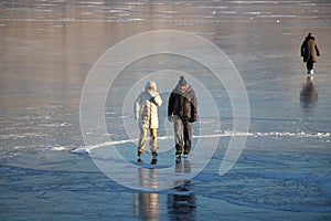 Osoyoos, British Columbia, Canada - December 31, 2021: Skaters on a frozen lake in winter