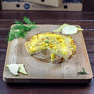 Ossetian pie with cheese on a wooden board