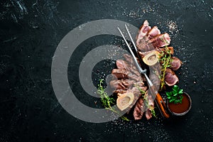 Osso buco cooked Veal shank on a black background. Top view. photo
