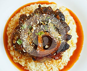 Osso buco is a Milanese speciality of cross-cut veal shanks braised with vegetables, white wine and broth. photo