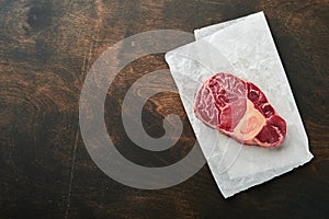 Osso Buco raw steak meat. Barbecue meat. Raw fresh cross cut veal shank and seasonings pepper, rosemary, thyme and salt
