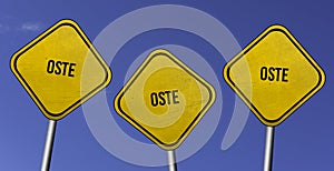Oste - three yellow signs with blue sky background