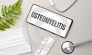 Osteomyelitis word on smartphone,stethoscope and green plant