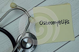 Osteomyelitis write on sticky notes isolated on Wooden Table. Medical concept