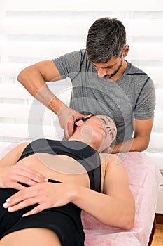 Osteopath performing cervical trust therapy photo