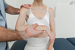 Osteopathic arm or shoulder massage. Elbow pain relief. Chiropractic treatment. Doctor doing shoulder blade therapy