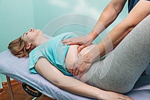 Osteopathic belly massage young woman photo