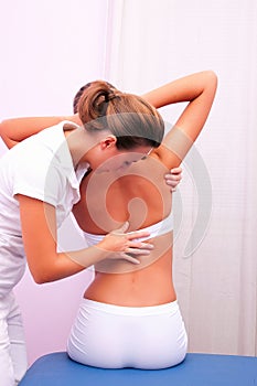 Osteopathic technique in rotation dorsal column photo