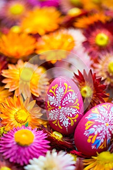 Hand-painted easter eggs with straw flowers