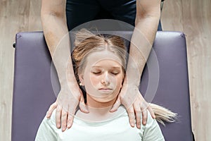 Ostheopatic treatment of a girl patient using CST gentle hands-on technique, central nervous system tension relieve