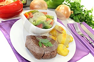 Ostrich steaks with baked potatoes