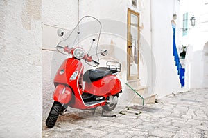 Ostuni, Apulia, Italy - red scooter in an alleyway photo