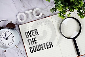 OTC - Over The Counter acronym on notepad, Business concept background