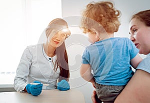 Otolaryngologist examines little boy. Medical equipment. Diagnostic