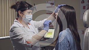 Otolaryngologist examines a patient in clinic